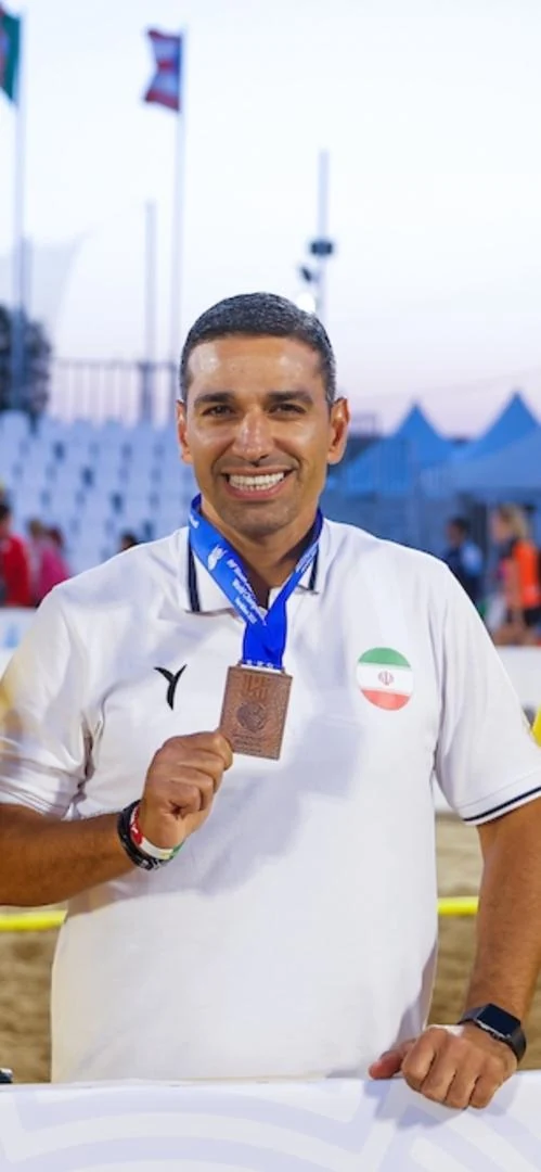Mehdi Ghashghaei Rad with a medal at a beach handball competition