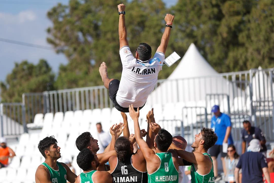 Iran beach handball team celebrating with Mehdi Ghashghaei Rad